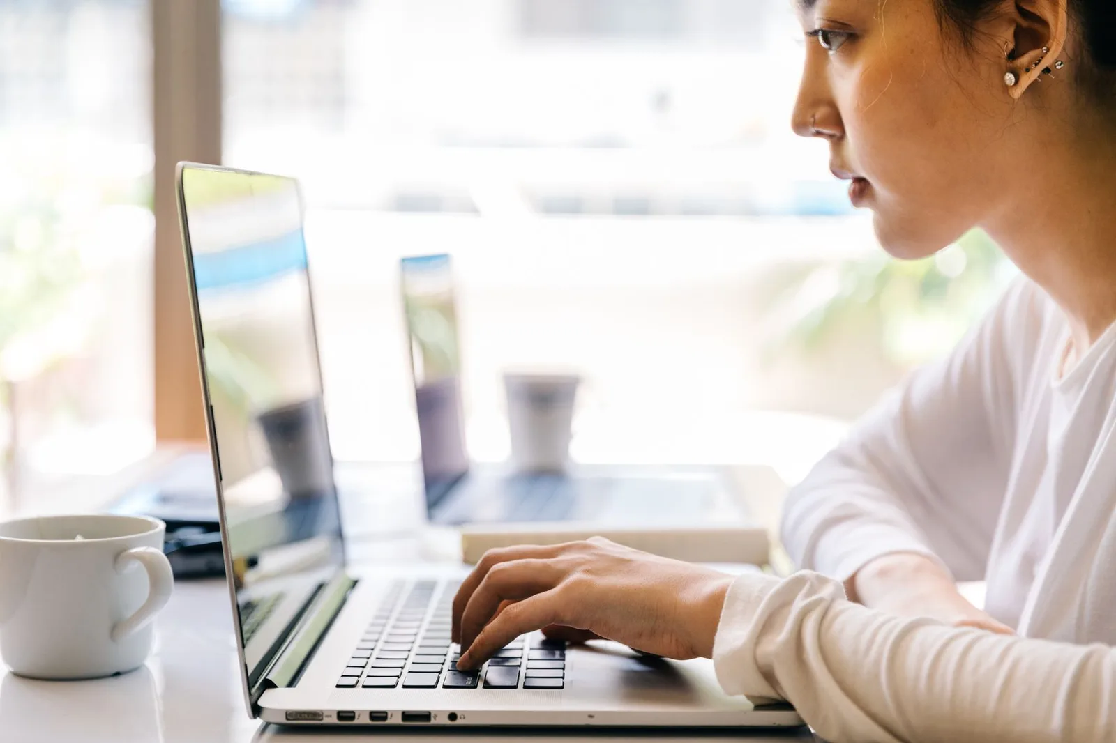 Sinh viên châu Á kiểm tra laptop tại cửa hàng