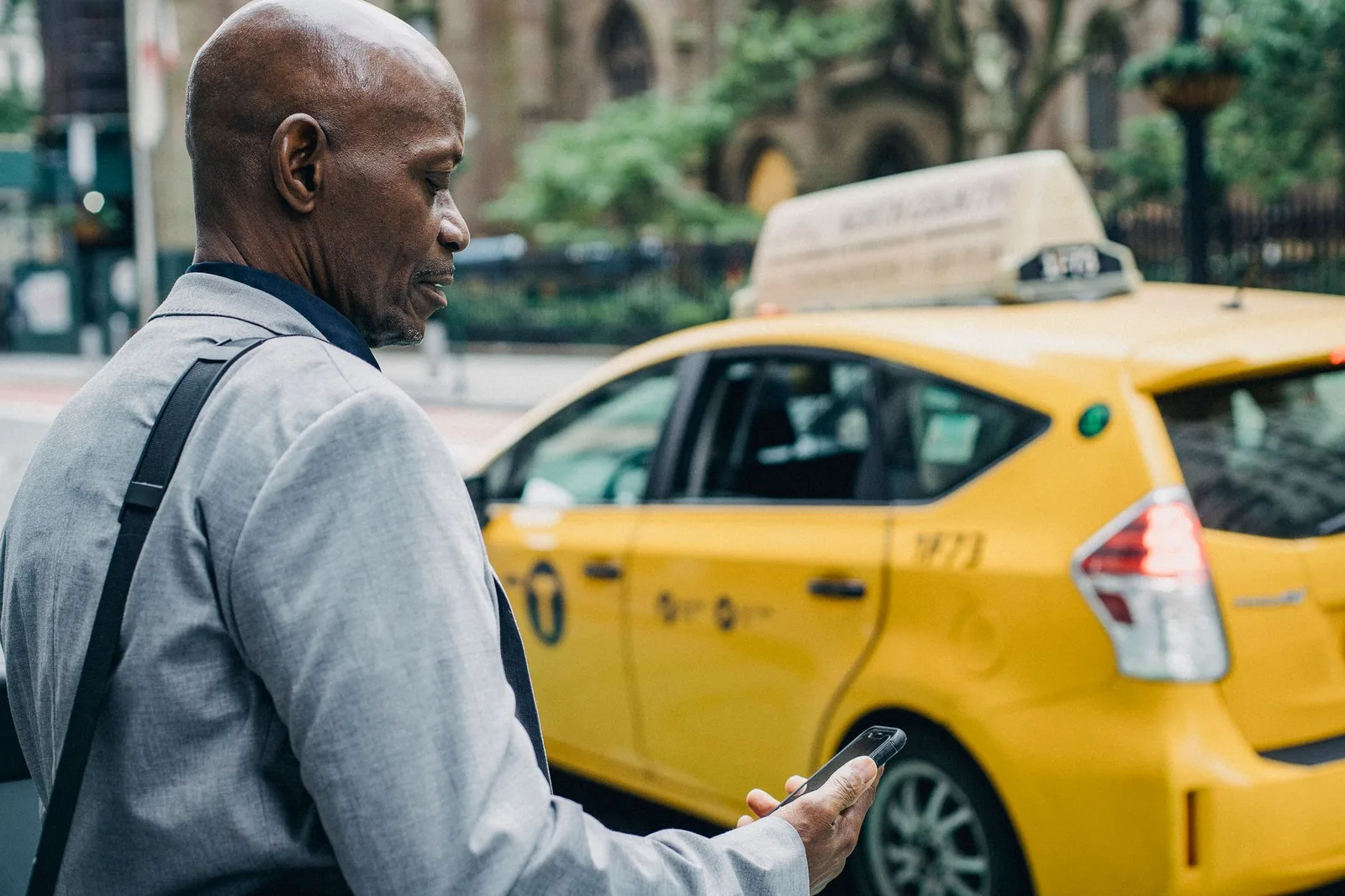 Du khách châu Á kiểm tra thông tin taxi trước khi lên xe