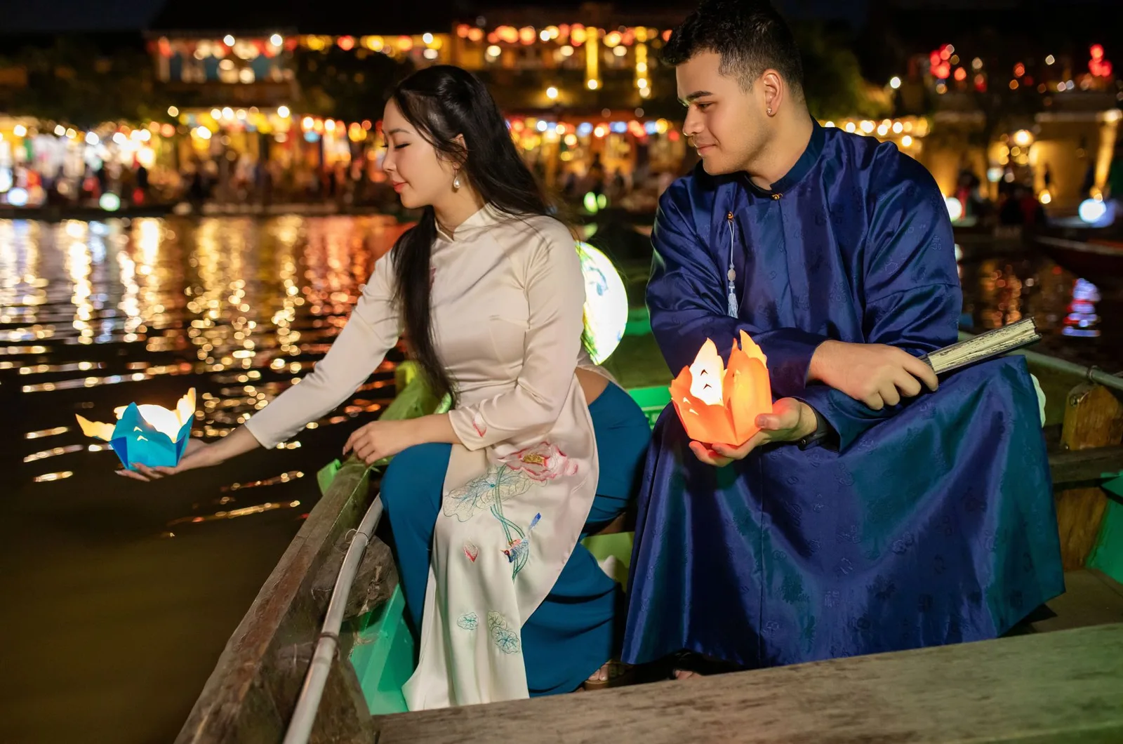 Du khách châu Á đi bộ khám phá Hội An buổi tối