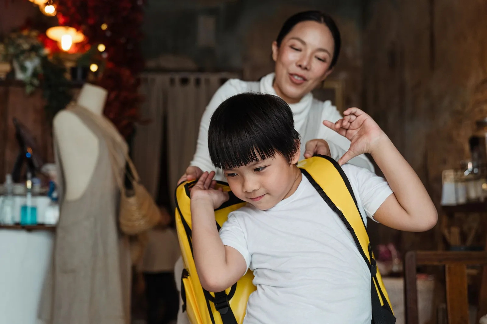 Gia đình châu Á đóng gói ba lô cho trẻ trước khi đi chơi